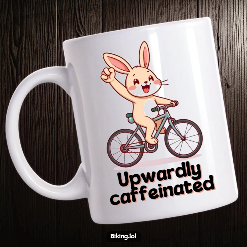 Funny rabbit mug showing a cheerful rabbit pumping its arm energetically while cycling uphill, inspiring determination.