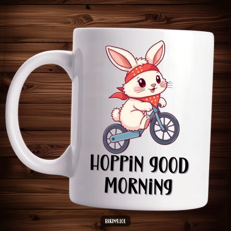 Funny fluffy bunny wearing a bandana, attempting a wheelie on a bike, on a ceramic mug, showing daring.