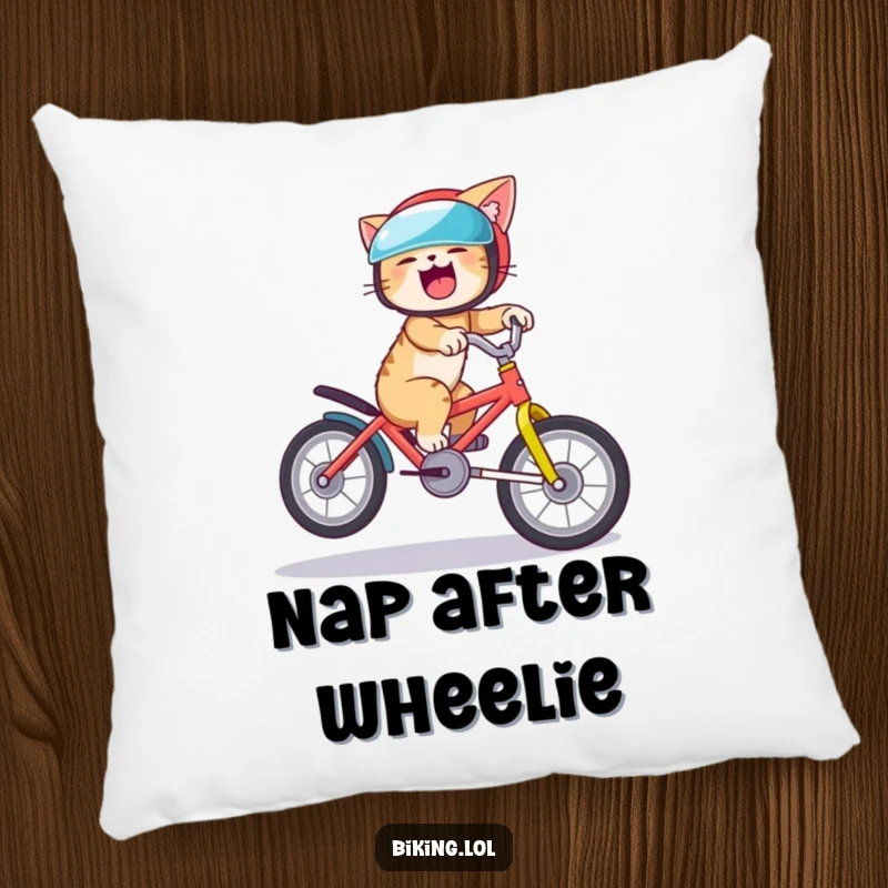 Funny cat pillow featuring a giggling cat attempting a bike wheelie, providing comfort and a humorous touch to any room.