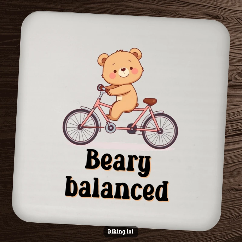 Funny drink coaster showing a smiling bear cub struggling to balance on a tandem bicycle alone.