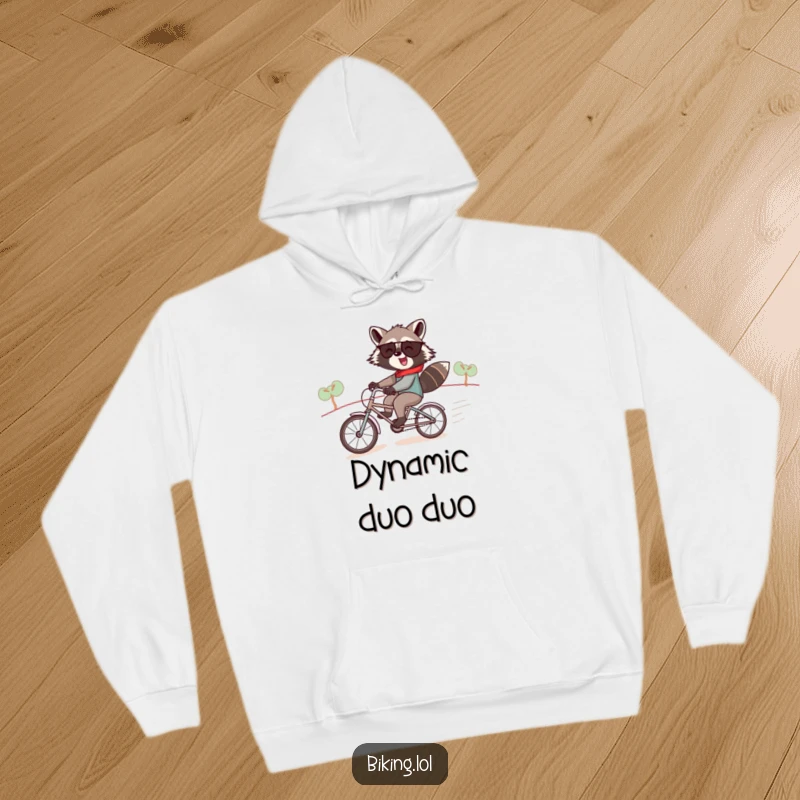 Funny raccoon hoodie, a jolly raccoon pair speeding downhill on a tiny tandem bike, cozy and humorous.