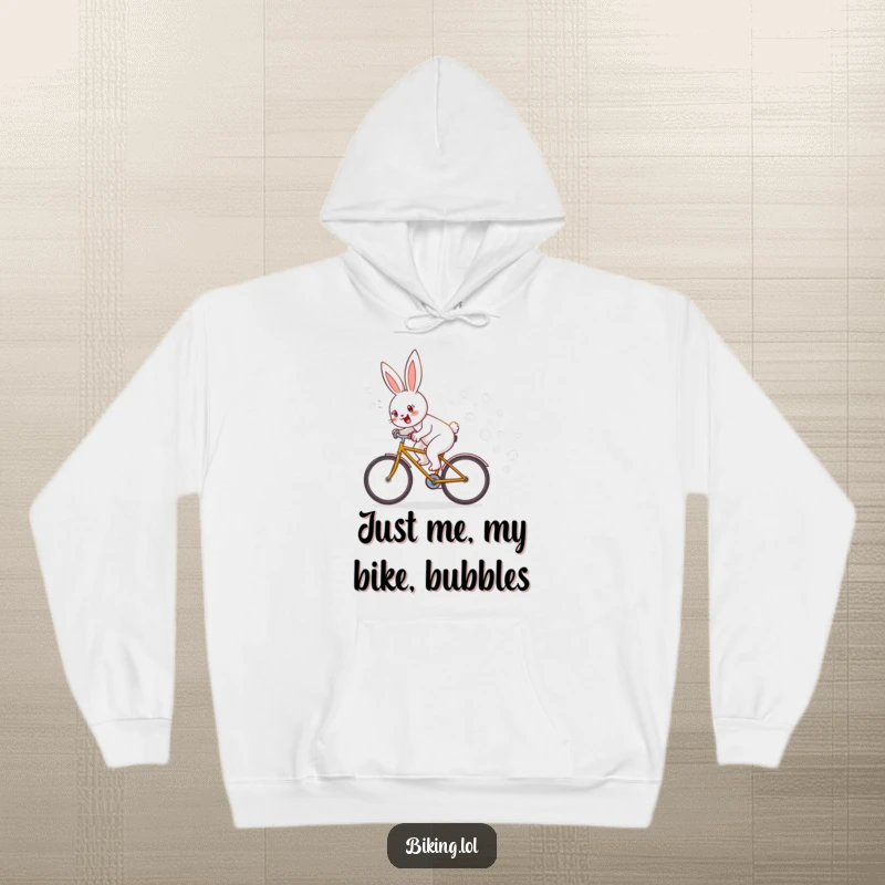 Funny hoodie featuring a joyful bunny speeding on a bike, creating a magical trail of floating bubbles, a cozy funny gift.