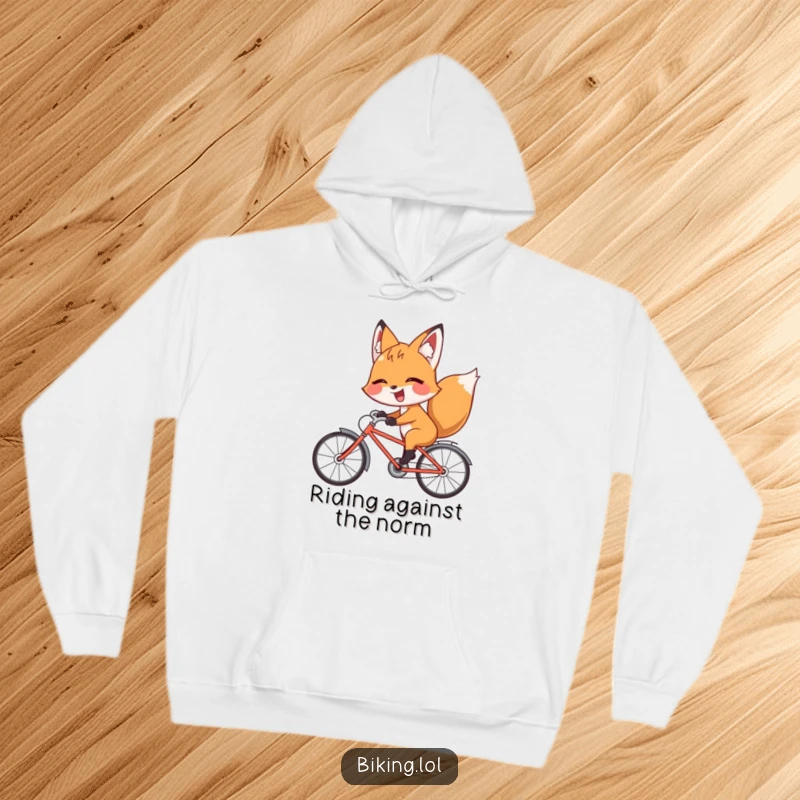 Funny fox hoodie showing a giggling fox riding a bicycle backward with a playful wink, comfortable and witty.