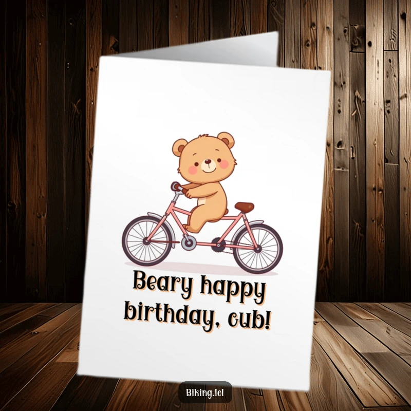 Funny Free Printable Birthday Card: Smiling bear cub wobbling on a tandem bike alone, comical balance challenge, DIY gift.
