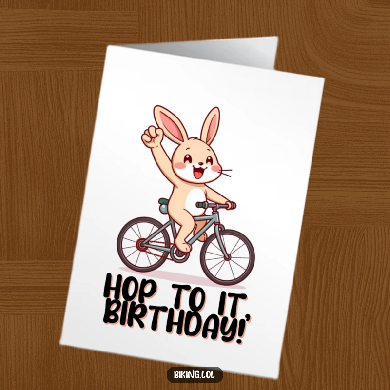 Funny Free Printable Birthday Card: Cheerful rabbit enthusiastically pumping its arm while cycling hard uphill on a bicycle.