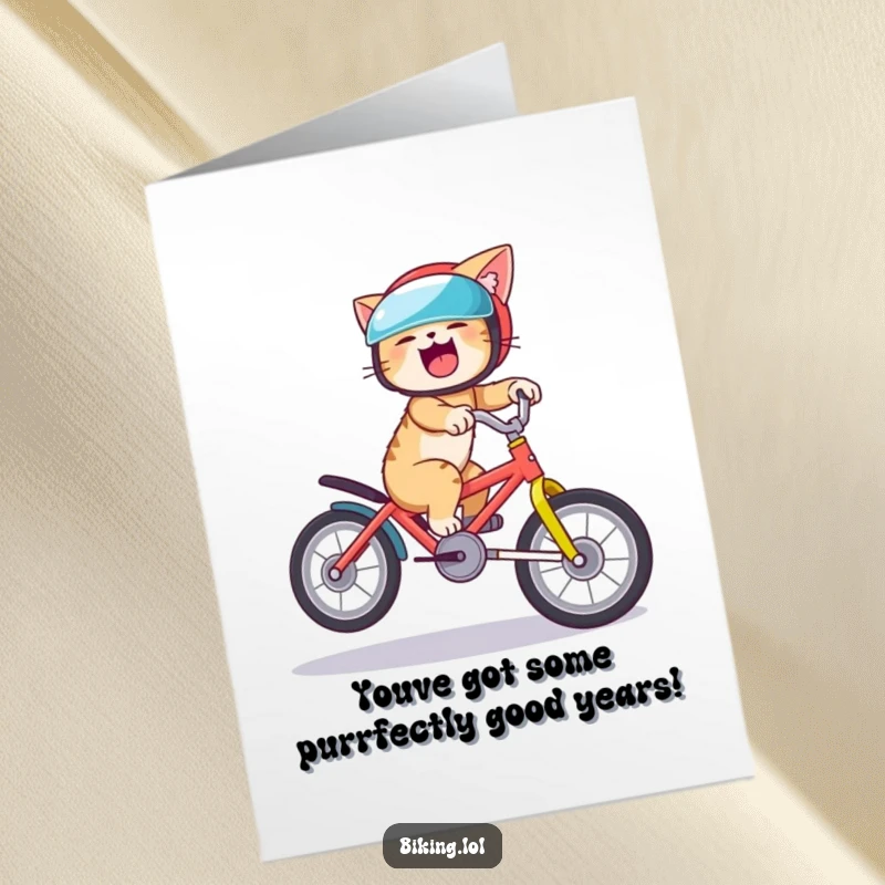 Funny Free Printable Birthday Card: A helmeted cat giggles wildly while attempting a daring wheelie on a vibrant bicycle.