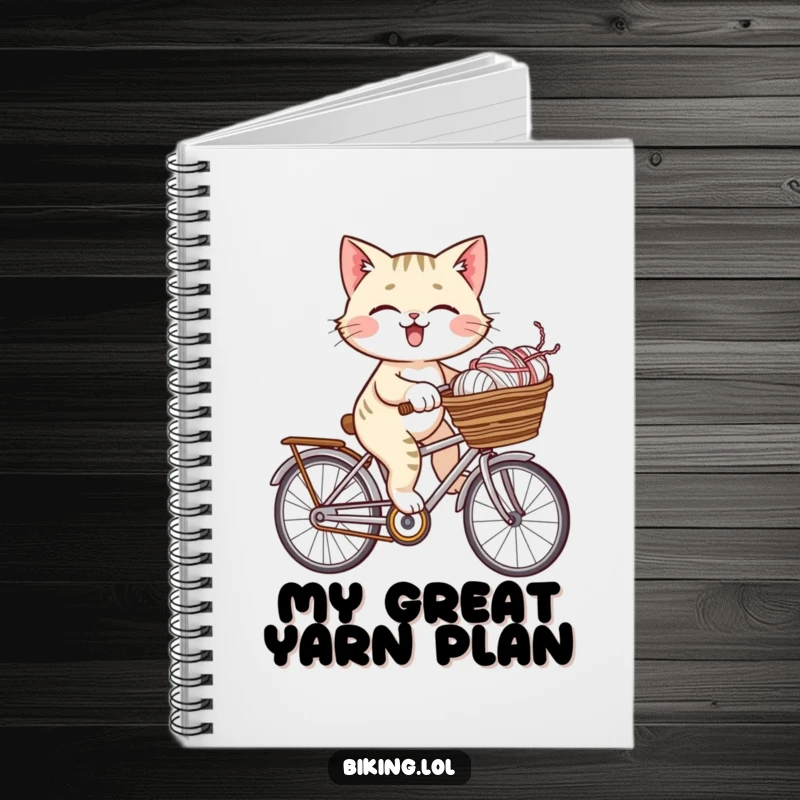 Funny giggling cat on a bicycle with a basket full of yarn, displayed on this humorous and inspiring notebook.