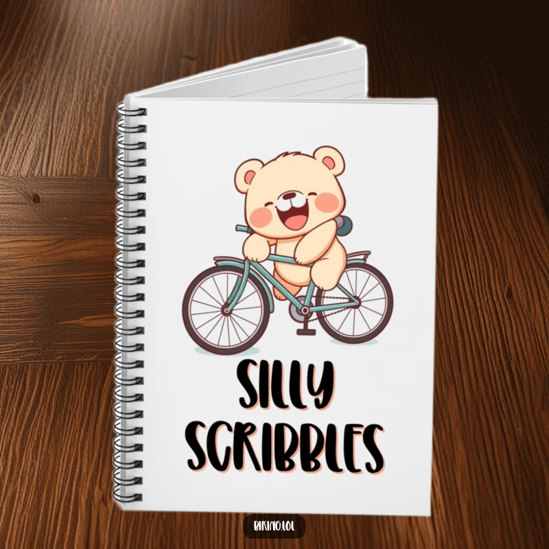 Funny notebook featuring a laughing bear cub falling off a bicycle with a silly face, perfect for notes.
