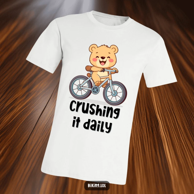 Funny t-shirt with a happy bear cub beaming while pedaling a bicycle equipped with unusually large wheels.