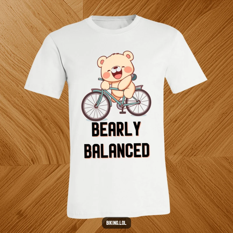 Funny t-shirt with a laughing bear cub mid-fall off a bicycle seat, making a wonderfully silly face.